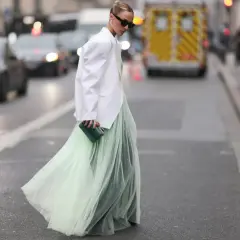 Ein langes Kleid mit Blazer kombinieren: fließender Tüllrock in Mintgrün trifft auf weißen Oversize-Blazer. Elegante Clutch in Smaragdgrün.
