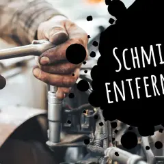 Hände mit Werkzeug reparieren einen Motor. Eingetrocknete Schmierflecken entfernen ist kein Problem mit den richtigen Mitteln.