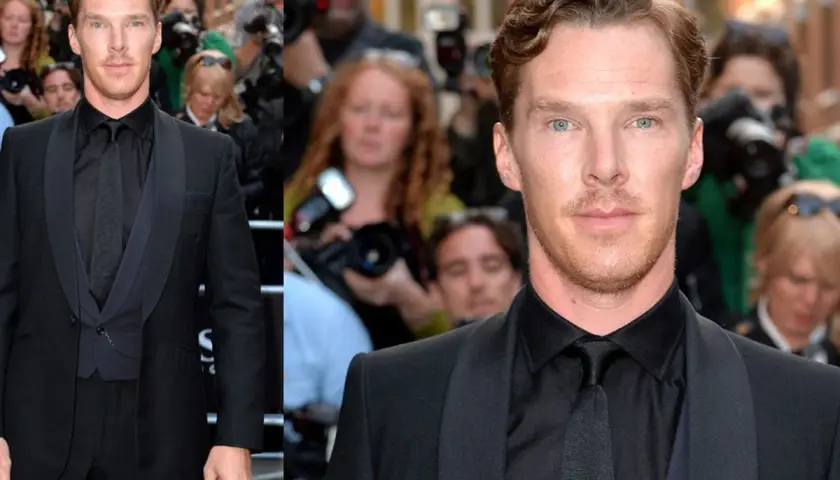 Benedict Cumberbatch im eleganten schwarzen Anzug und schwarzem Hemd, umgeben von Fotografen.