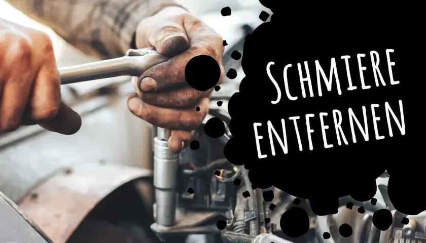 Hände mit Werkzeug reparieren einen Motor. Eingetrocknete Schmierflecken entfernen ist kein Problem mit den richtigen Mitteln.
