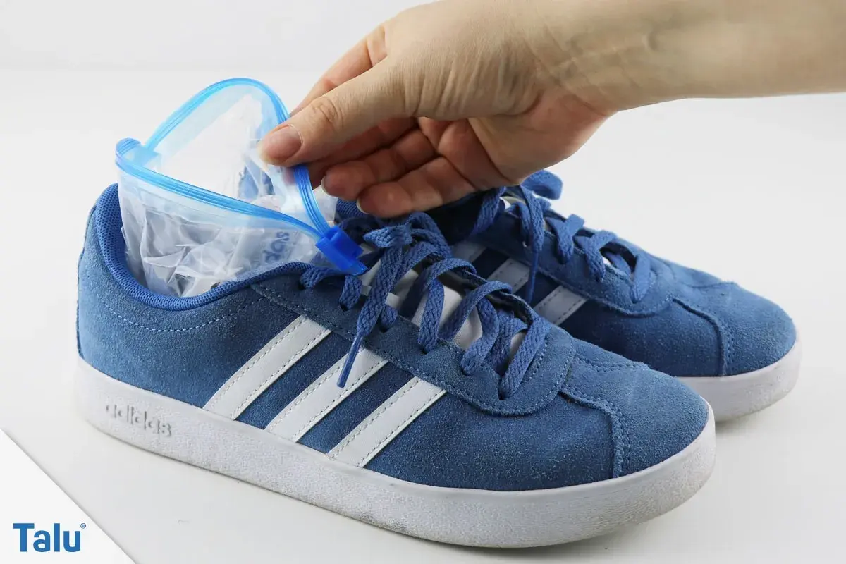 Blauer Sneaker wird mit einem gefüllten Gefrierbeutel geweitet. So kann man Schuhe weiten.